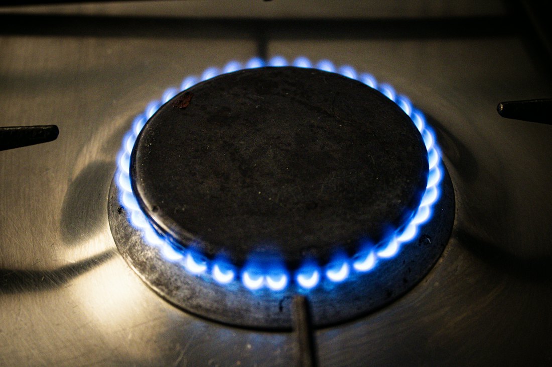 A blue gas flame on a burner (illustrative stock photo)